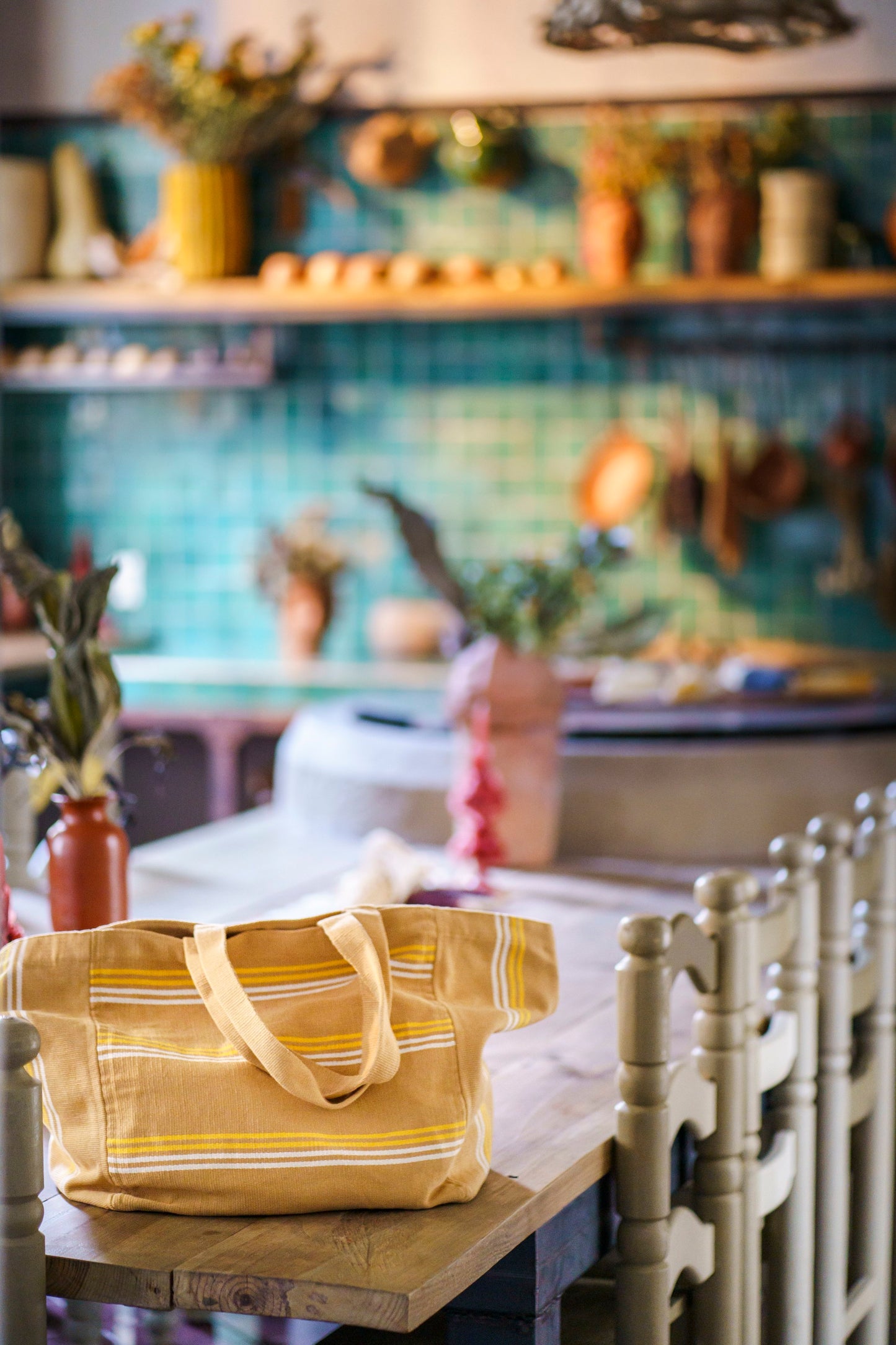 Essential handwoven travel bag in Mexico on a table with colorful tile