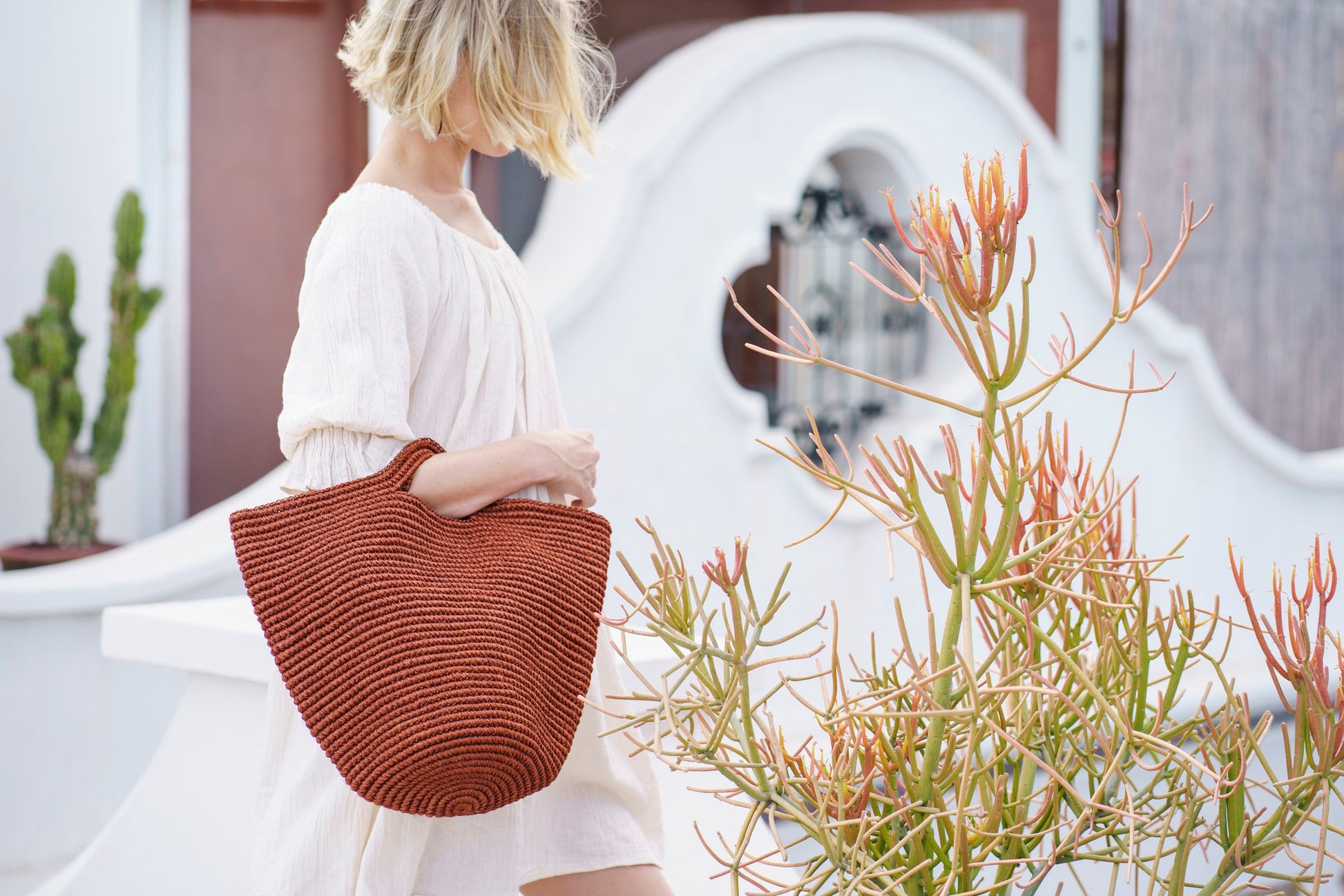 Woven basket bag on woman's arm 